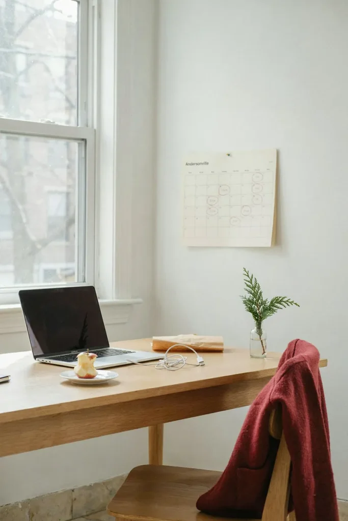 A wall calendar with every second Friday circled in red pencil above a desk, a christmas savings challenge biweekly plan