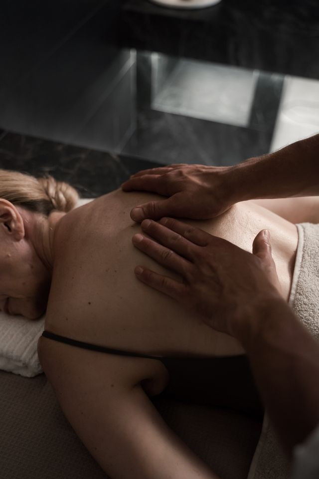 Woman relaxing during a back massage, an experience gift she would never book herself